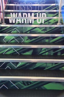 Image of the graphics on the stairs at Glo gym